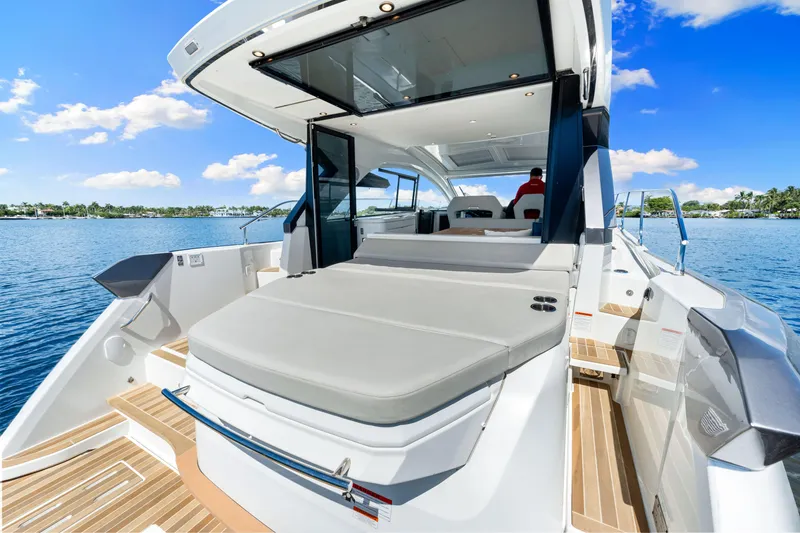 Slide: The Image of 2024 Beneteau Gran Turismo 45 yacht, luxurious deck view, sunny day, calm waters. - 32
