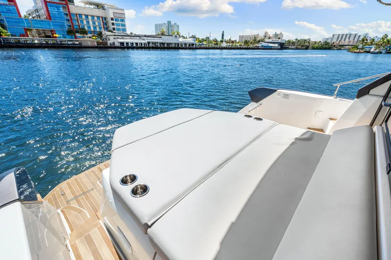 Slide: The Image of 2024 Beneteau Gran Turismo 45 yacht with sun deck, overlooking sparkling blue water. - 34