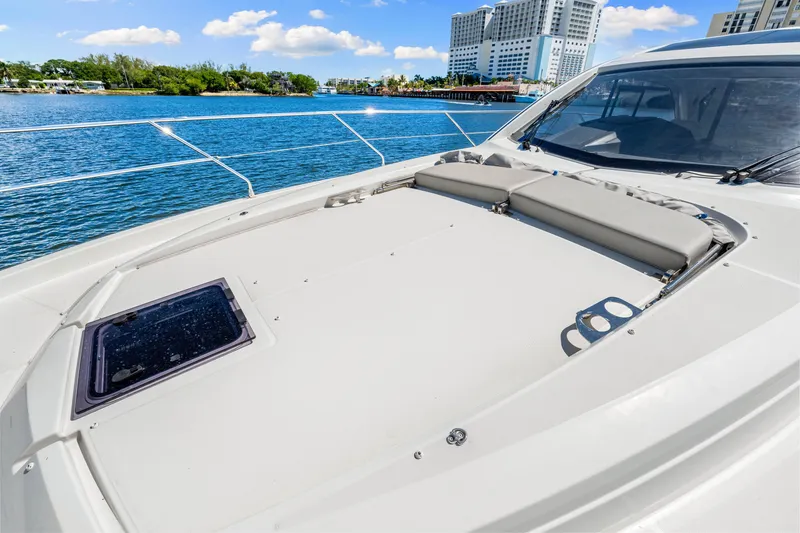 Slide: The Image of 2024 Beneteau Gran Turismo 45 yacht deck with sunbathing area and scenic waterfront view. - 41