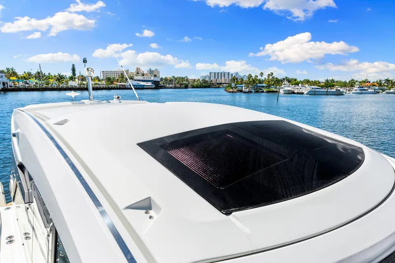 Slide: The Image of 2024 Beneteau Gran Turismo 45 yacht on serene water with clear blue sky. - 44