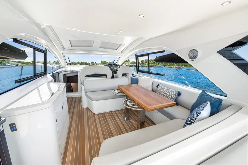 Slide: The Image of Luxurious interior of 2024 Beneteau Gran Turismo 45 yacht with elegant seating and wooden table. - 45