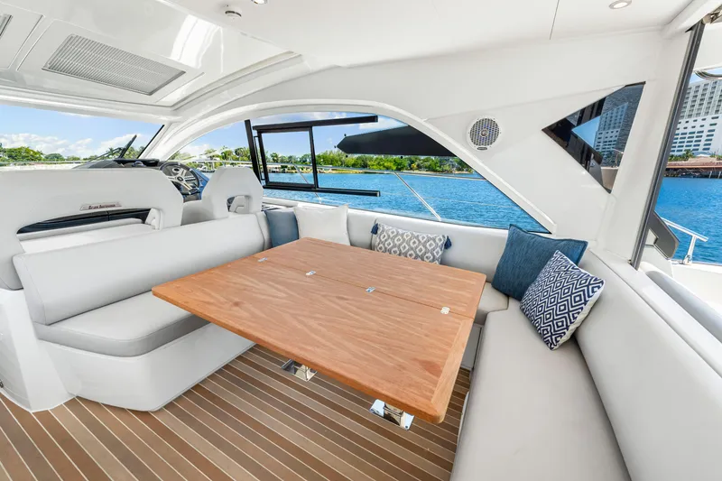 Slide: The Image of Luxurious interior of 2024 Beneteau Gran Turismo 45 yacht with elegant seating and wooden table. - 46