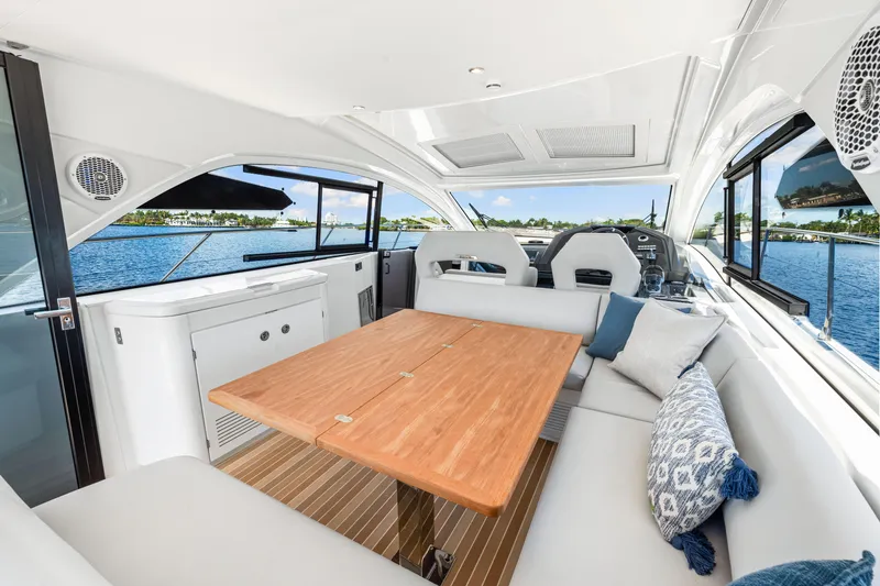 Slide: The Image of 2024 Beneteau Gran Turismo 45 yacht interior with elegant seating and wooden table. - 47