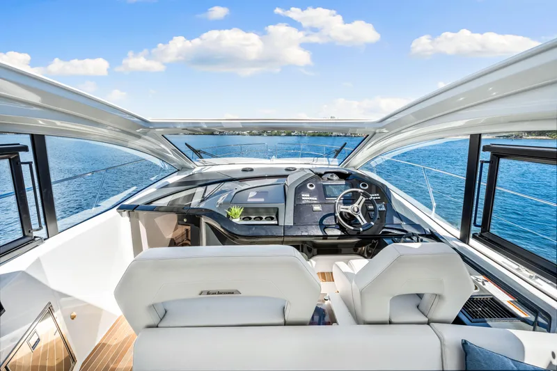 Slide: The Image of 2024 Beneteau Gran Turismo 45 yacht cockpit with modern steering and panoramic sea view. - 53