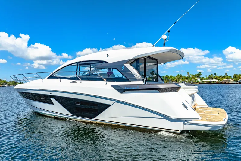 Slide: The Image of 2024 Beneteau Gran Turismo 45 yacht on water under clear blue sky. - 6