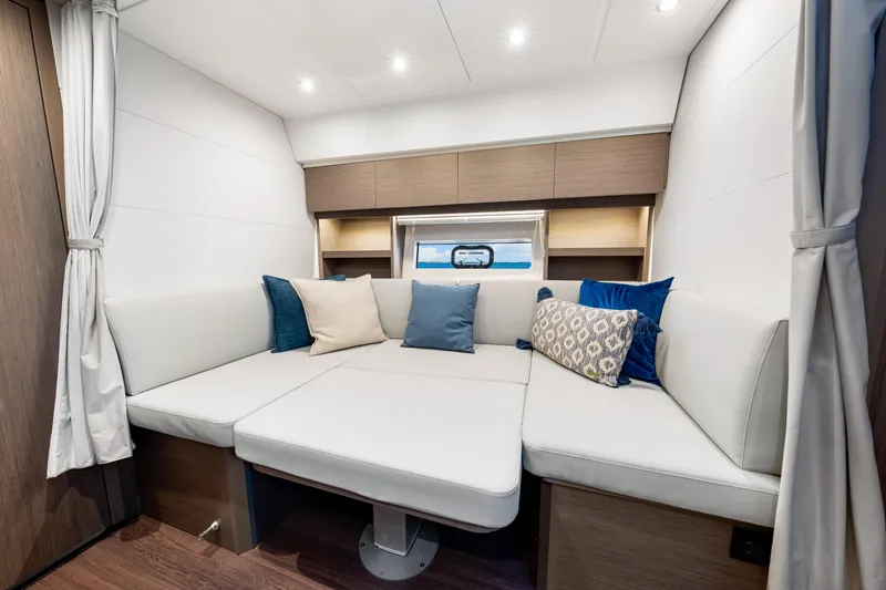 Slide: The Image of Luxurious interior of 2024 Beneteau Gran Turismo 45 yacht with plush seating and cushions. - 62