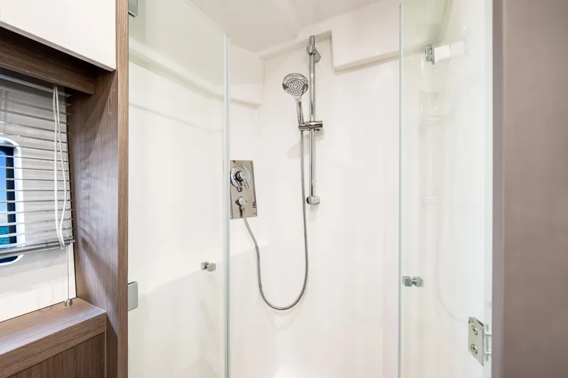 Slide: The Image of Modern shower in 2024 Beneteau Gran Turismo 45 yacht, featuring sleek glass doors and chrome fixtures. - 69
