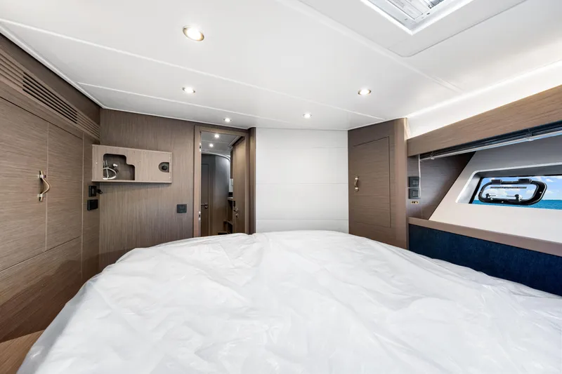 Slide: The Image of 2024 Beneteau Gran Turismo 45 cabin interior with modern wood finishes and window view. - 72