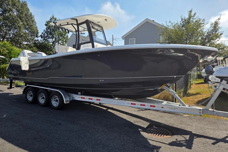 The Image of 2026 Sea Hunt Gamefish 27 Forward Seating boat on trailer, parked outdoors. - 1