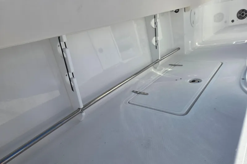 Slide: The Image of 2026 Sea Hunt Gamefish 27 Forward Seating interior with storage compartment and stainless steel railing. - 12