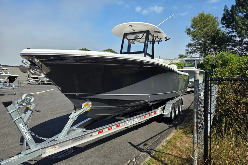Slide: The Image of 2026 Sea Hunt Gamefish 27 Forward Seating boat on trailer in outdoor setting. - 6
