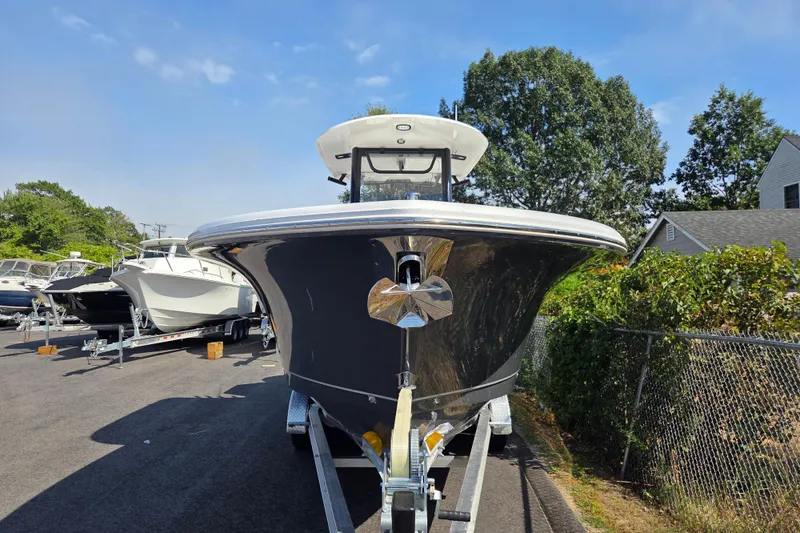 Slide: The Image of 2026 Sea Hunt Gamefish 27 Forward Seating boat on trailer, parked outdoors. - 7