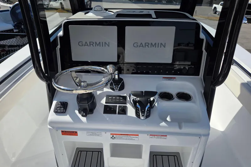 Slide: The Image of 2026 Sea Hunt Gamefish 27 helm with dual Garmin displays and modern controls. - 9