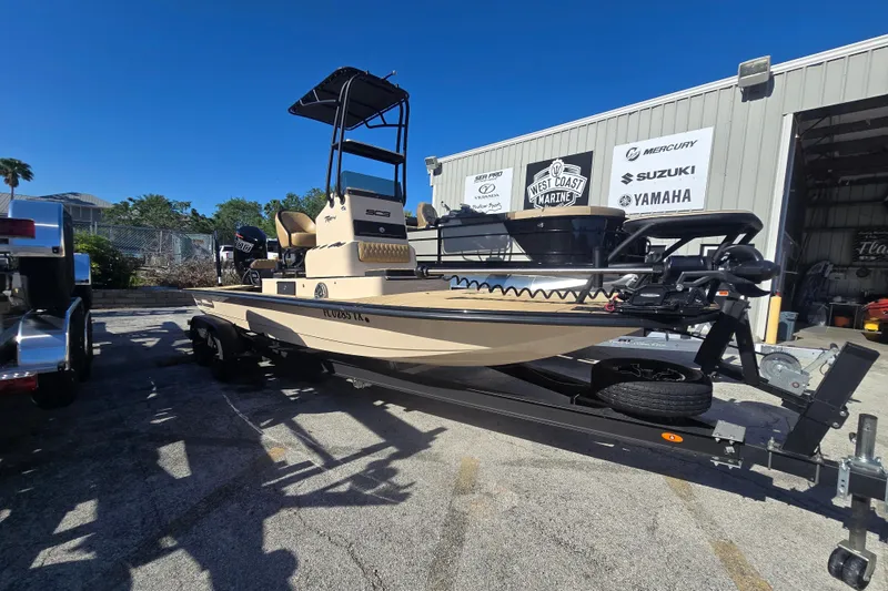 The Image of 2025 SCB R24 boat on trailer outside marine shop, featuring Mercury and Yamaha logos. - 1
