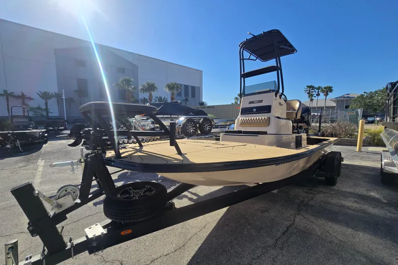 Slide: The Image of 2025 SCB R24 boat on trailer in sunny outdoor setting. - 4