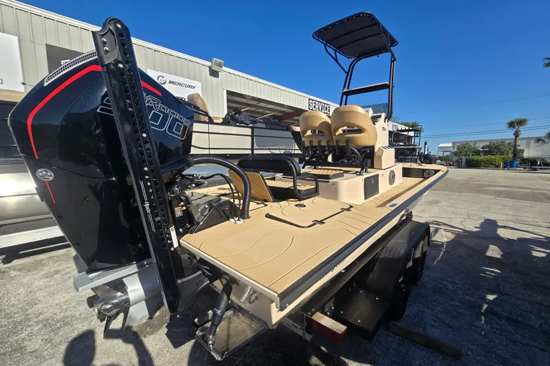 Slide: The Image of 2025 SCB R24 boat with powerful engine, parked outdoors under clear blue sky. - 9