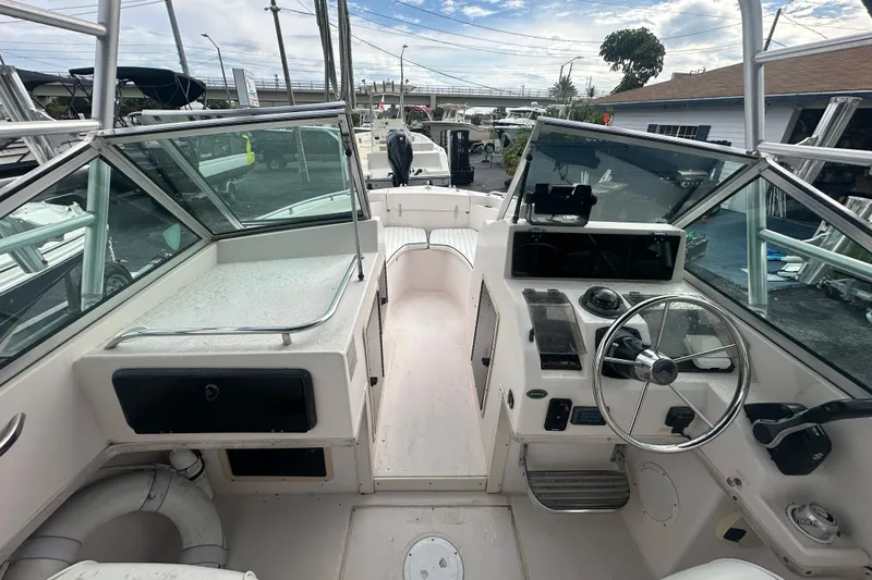 Slide: The Image of 1998 Grady-White Tournament 223 boat interior with steering wheel and seating area. - 11