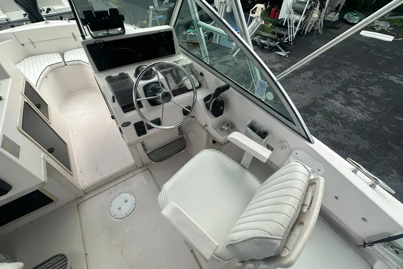 Slide: The Image of 1998 Grady-White Tournament 223 boat cockpit with steering wheel and seating. - 13