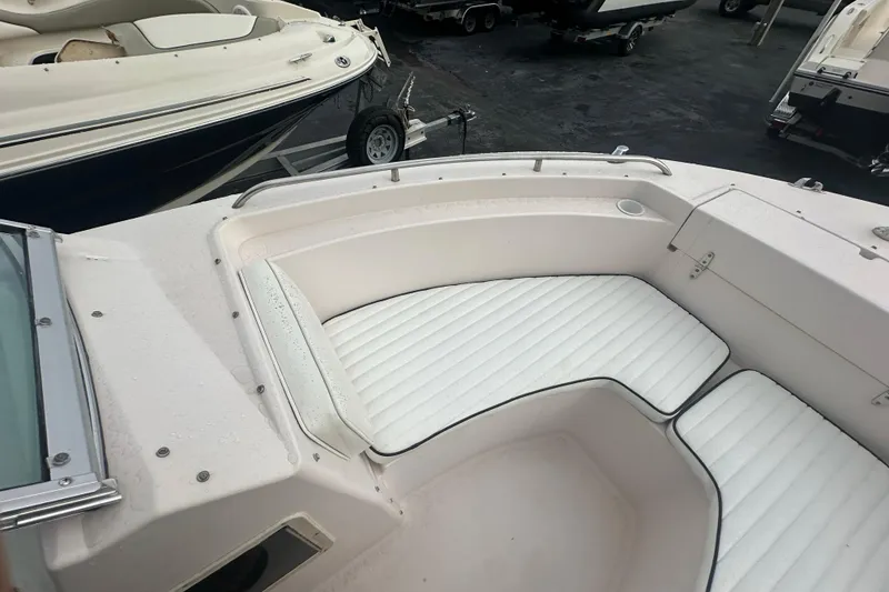 Slide: The Image of 1998 Grady-White Tournament 223 boat with white cushioned seating in the bow area. - 18