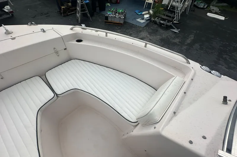 Slide: The Image of 1998 Grady-White Tournament 223 boat with white cushioned seating in the bow area. - 19