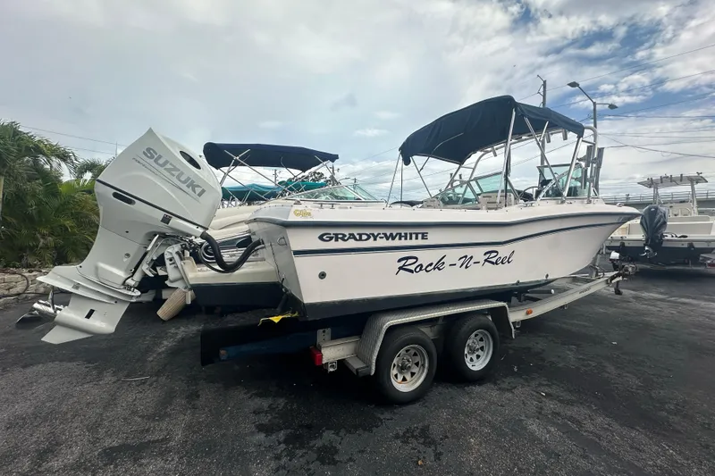 Slide: The Image of 1998 Grady-White Tournament 223 boat on trailer with Suzuki outboard motor. - 2