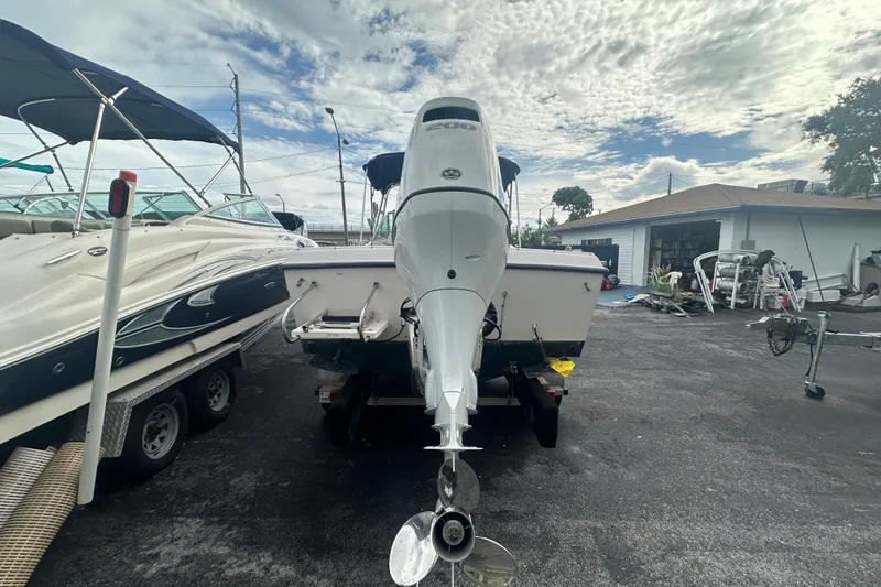 Slide: The Image of 1998 Grady-White Tournament 223 boat with outboard motor in a parking lot. - 4