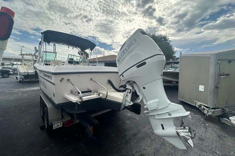 Slide: The Image of 1998 Grady-White Tournament 223 boat with Suzuki outboard motor on trailer. - 5