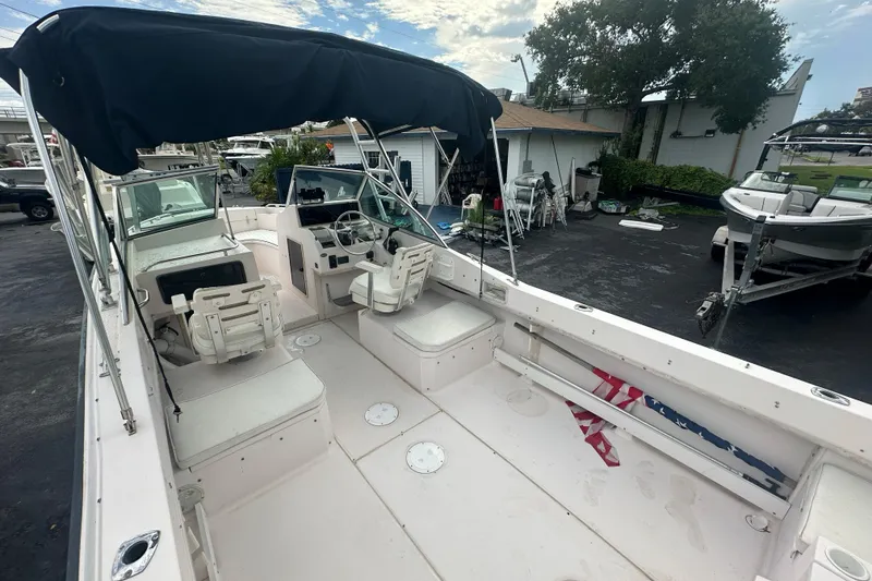 Slide: The Image of 1998 Grady-White Tournament 223 boat with canopy, spacious deck, and seating. - 7