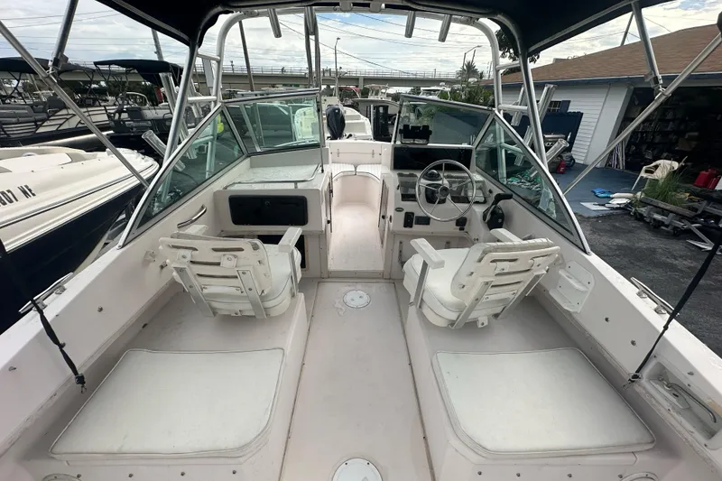 Slide: The Image of 1998 Grady-White Tournament 223 boat interior with seating and steering wheel. - 9