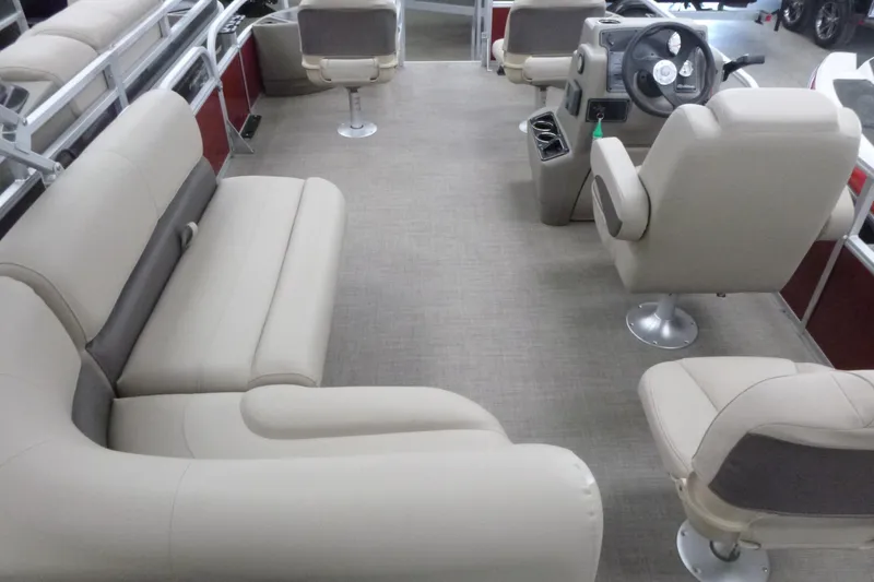 Slide: The Image of 2025 Sun Tracker Bass Buggy 18 DLX interior with beige seating and steering console. - 3