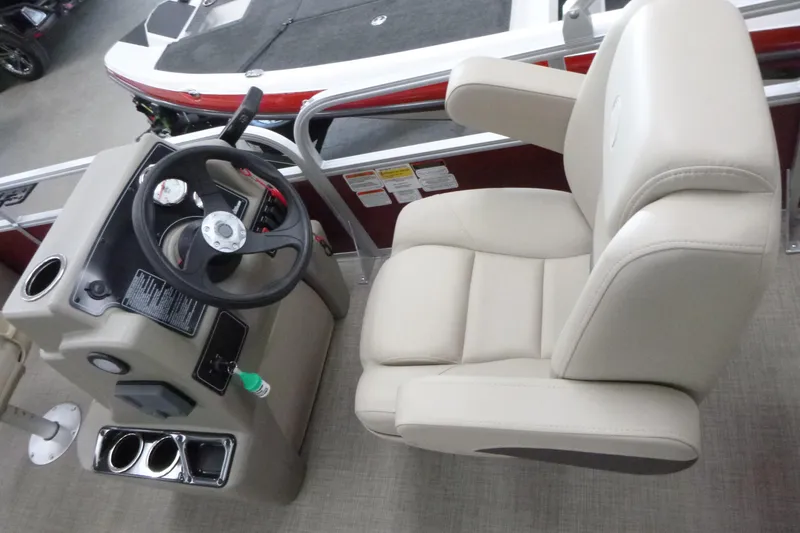 Slide: The Image of 2025 Sun Tracker Bass Buggy 18 DLX boat interior with steering console and captain's chair. - 4