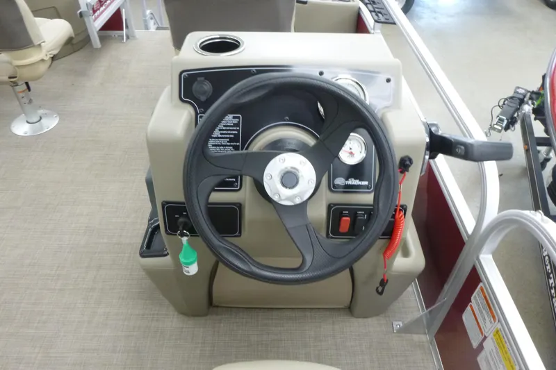 Slide: The Image of 2025 Sun Tracker Bass Buggy 18 DLX steering console with controls and gauges. - 5