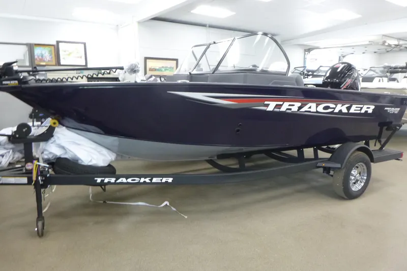 The Image of 2026 Tracker Pro Guide V-175 WT boat on trailer in showroom. - 0