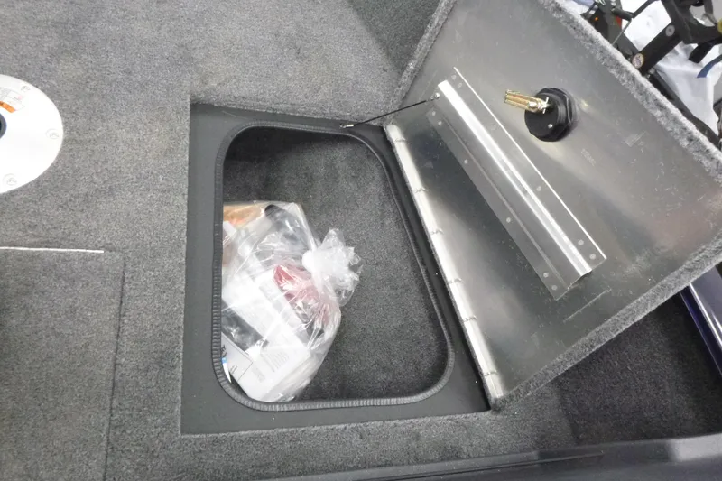 Slide: The Image of 2026 Tracker Pro Guide V-175 WT boat storage compartment with gray trim and carpeted interior. - 10