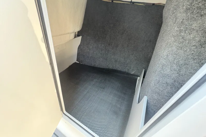 Slide: The Image of Interior storage compartment of 2020 Chaparral 21 SSi boat, featuring carpeted walls. - 11