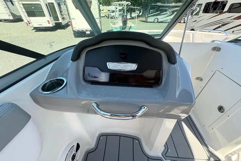 Slide: The Image of 2020 Chaparral 21 SSi boat dashboard with cup holder and storage compartment. - 12