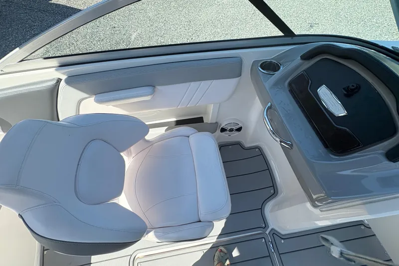 Slide: The Image of 2020 Chaparral 21 SSi boat interior with white seating and dashboard. - 13