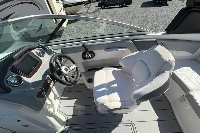 Slide: The Image of 2020 Chaparral 21 SSi boat interior with steering wheel and captain's seat. - 14