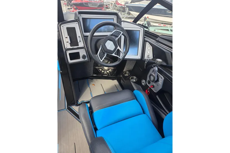 Slide: The Image of 2021 Supra SE 450 boat cockpit with modern steering and blue seating. - 10