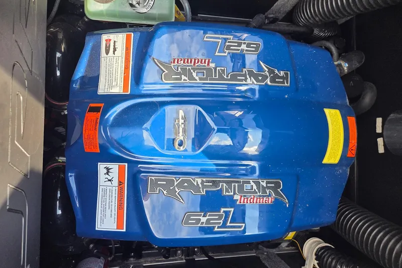 Slide: The Image of 2021 Supra SE 450 engine, Raptor Indmar 6.2L, blue cover with warning labels. - 15