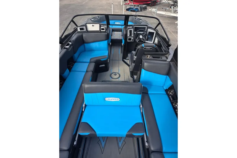 Slide: The Image of 2021 Supra SE 450 boat interior with blue and black seating, modern dashboard, and spacious layout. - 6
