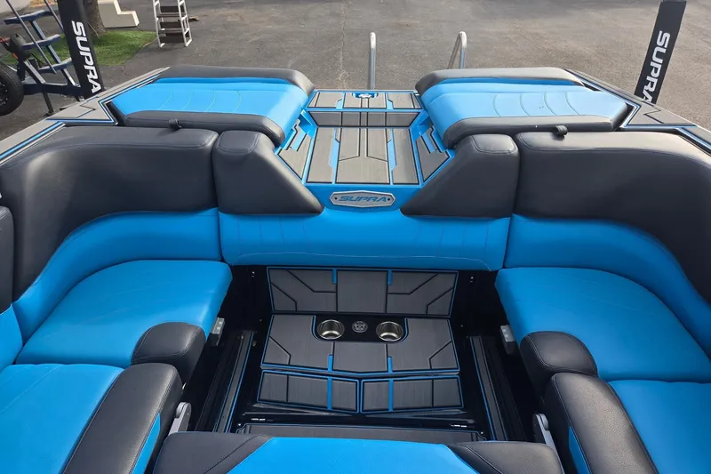 Slide: The Image of 2021 Supra SE 450 boat interior with blue and black seating, stylish design. - 7