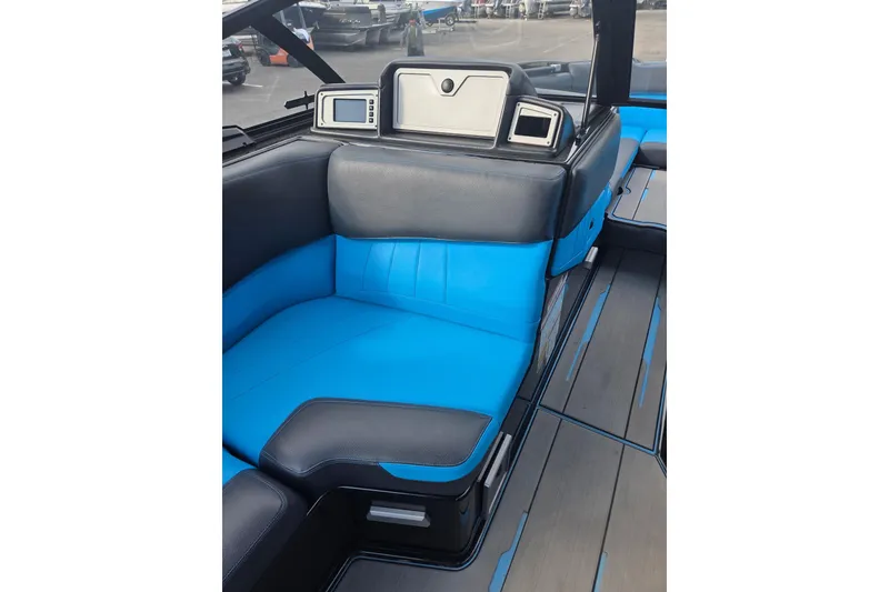 Slide: The Image of 2021 Supra SE 450 interior with blue and black seating, modern dashboard, and sleek design. - 9