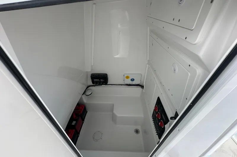 Slide: The Image of Interior of 2026 Bluewater 25t boat, featuring storage compartments and electrical panel. - 14