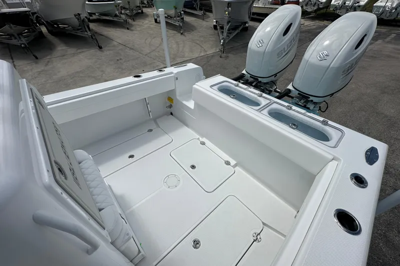 Slide: The Image of 2026 Bluewater 25t boat with dual Suzuki outboard engines, spacious deck, and storage compartments. - 16