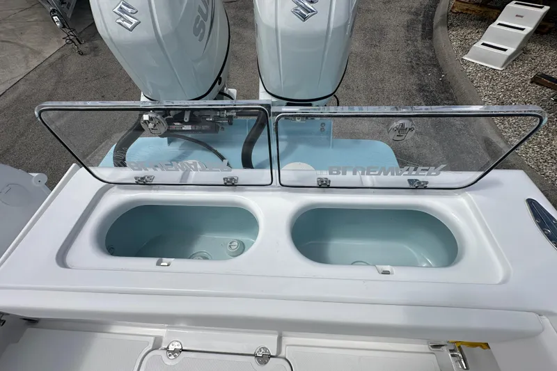 Slide: The Image of 2026 Bluewater 25t boat with dual live wells and Suzuki outboard engines. - 17