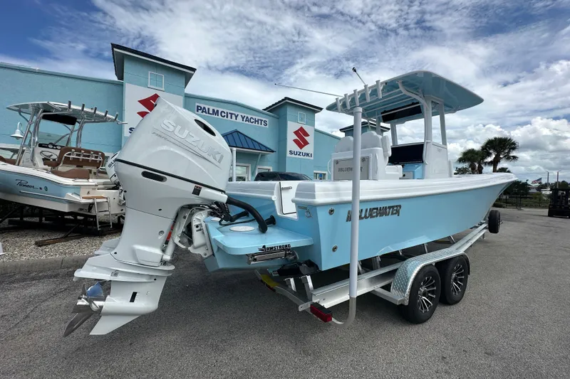 Slide: The Image of 2026 Bluewater 25t boat with Suzuki engine at Palm City Yachts dealership. - 5