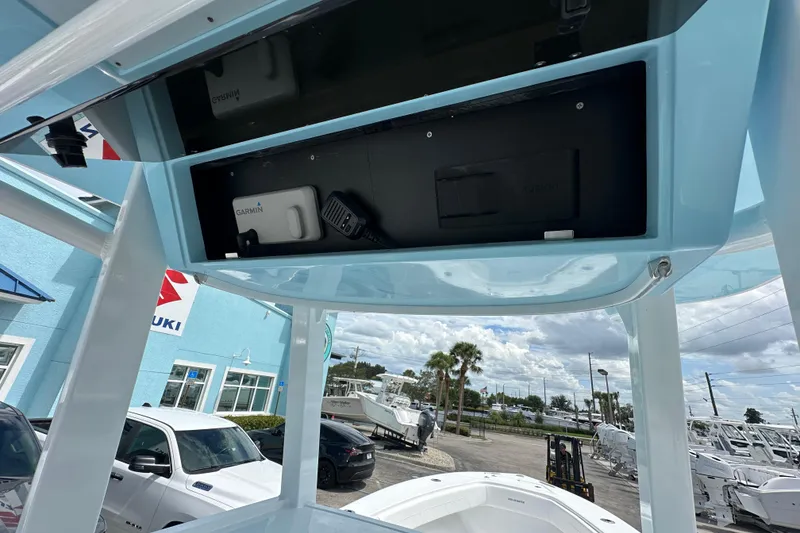 Slide: The Image of 2026 Bluewater 25t boat console with Garmin electronics, parked at dealership. - 7