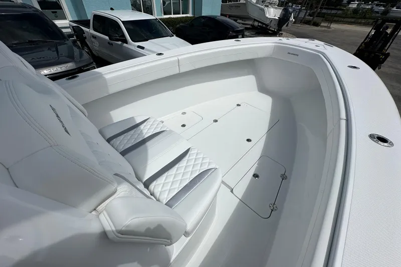 Slide: The Image of 2026 Bluewater 25t boat interior with white seating and storage compartments. - 8