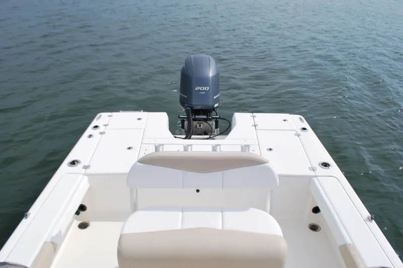 Slide: The Image of 2016 Robalo 226 Cayman boat with outboard motor on calm water. - 10